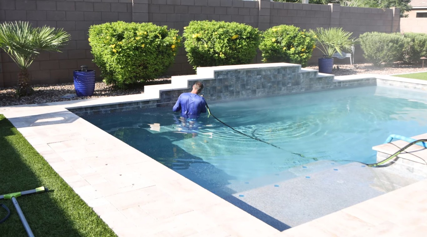 Pool technician cleaning pool in Turlock, CA